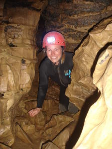 Ang squeezing through an undergroud cave