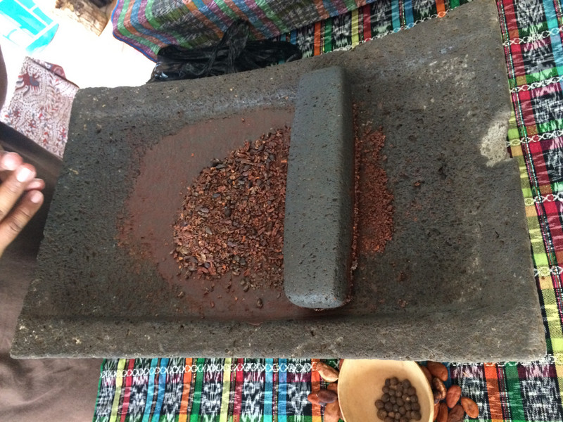Grinding cocoa bean the traditional way 