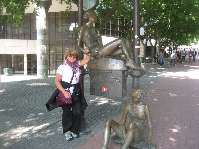 Bronze post box statue featuring 2 girls taking a break from skateboarding