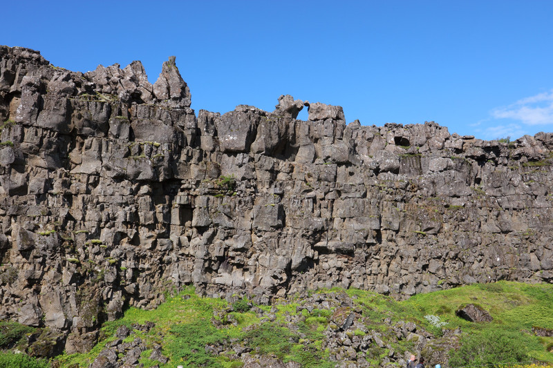 Vertical cliff face along one side of the fissure