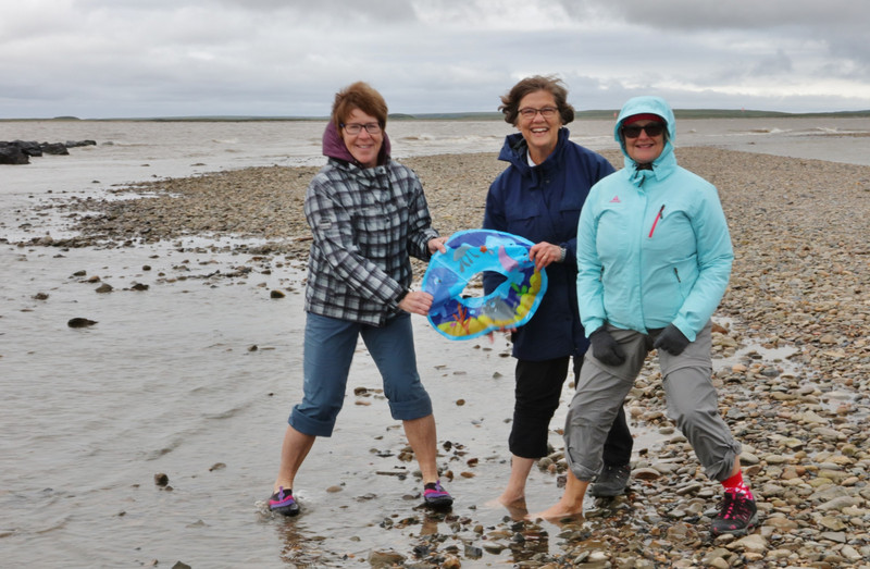The girls dipping a foot into the Arctic Ocean at the north point in Tuktoyaktuk