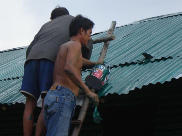 someone ( I think it's Ulee) & Arnon doing the roof of the volunteer house