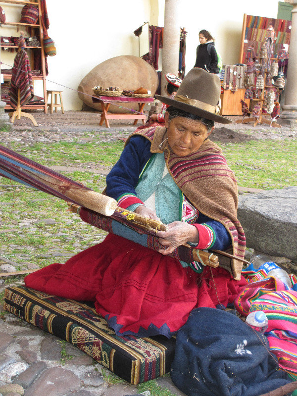 Lady weaving a mat