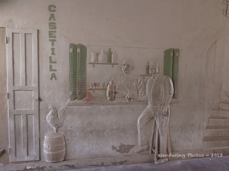 Wall carvings depicting life in old times in Puerto de Mogan