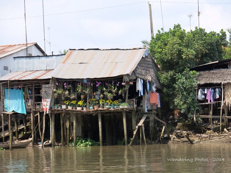 Small stilt houses on the edge of the Mekong River