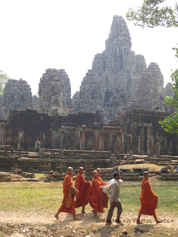 Buddhist monks walking in front of the Bayon - Angkor Thom