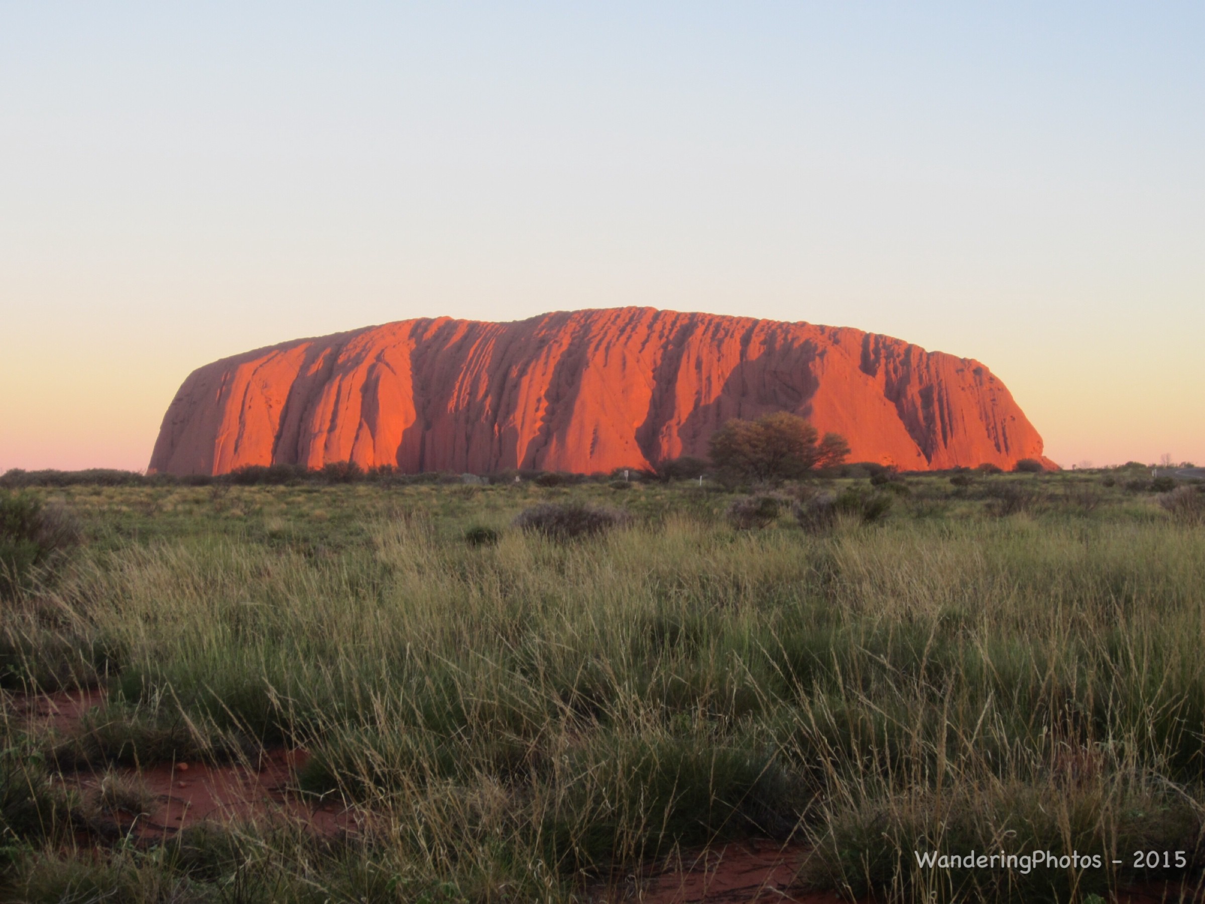 The Changing Colours Of Uluru At Sunset Photo