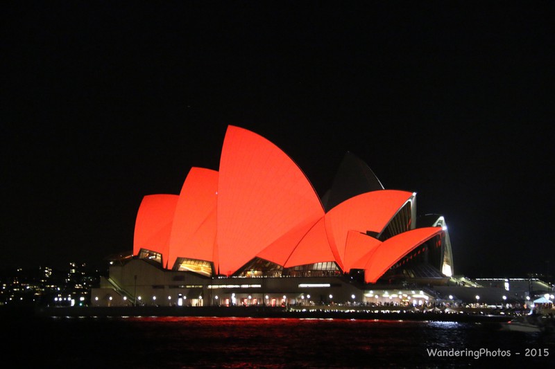 Sydney Opera House glowing red at night
