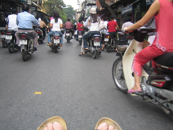Sitting in a tuk tuk in Hanoi - view of lots of motorbikes racing past