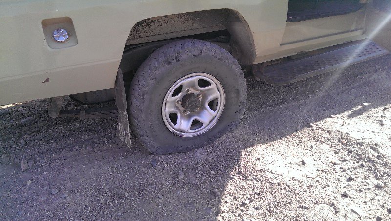 Flat tyre on our dodgy truck right in the middle of a lion infested area!