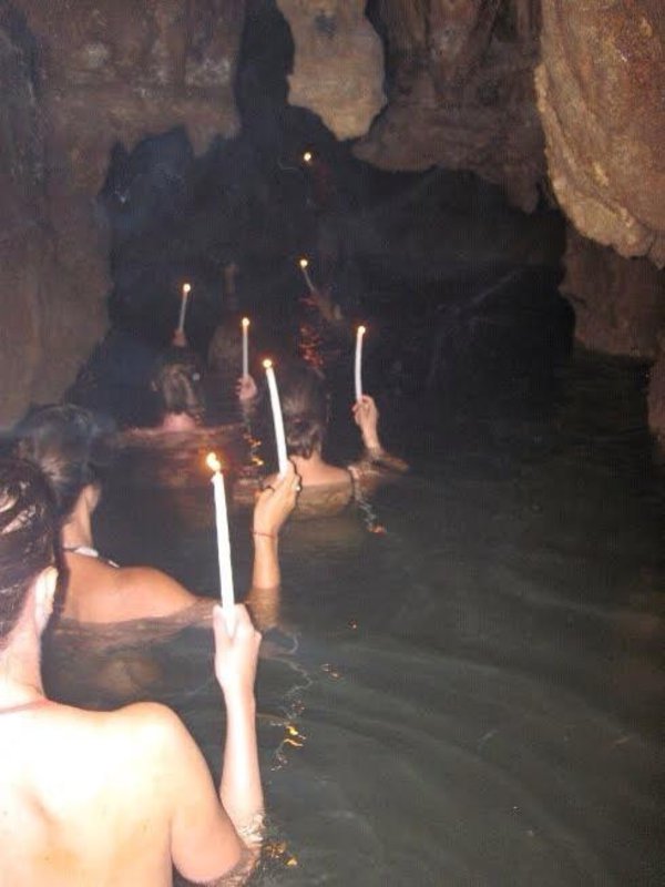 Using candles for lights in the water logged caves