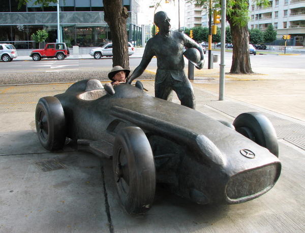 Ben poses with Manuel Fangio and his car