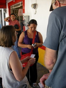 Buying a bus ticket at the corner of Aguacate and Carranza