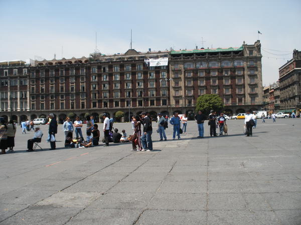 People standing in shadow of flag - Zocalo Square