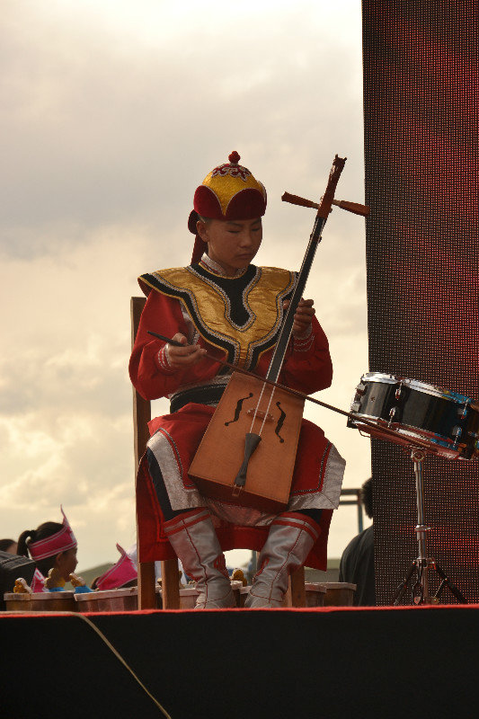 The neighbor playing traditional instrument for Naadam