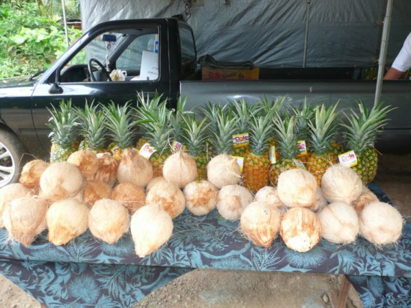 Roadside stand of coconuts and pineapples