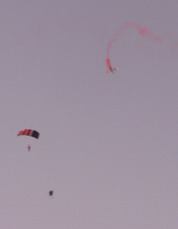 Tandem jumpers carrying an American flag landed on the starting line during the opening ceremonies at the MCM 2011.