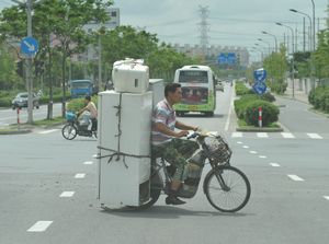 2 refrigerators, microwave and a rice cooker bicycle man