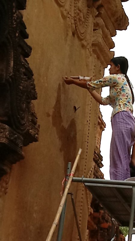 WOMAN REPAIRING A WALL