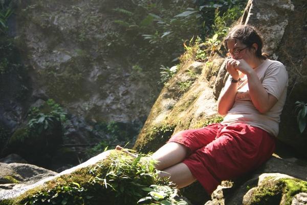 Dorien playing harmonica at waterfall