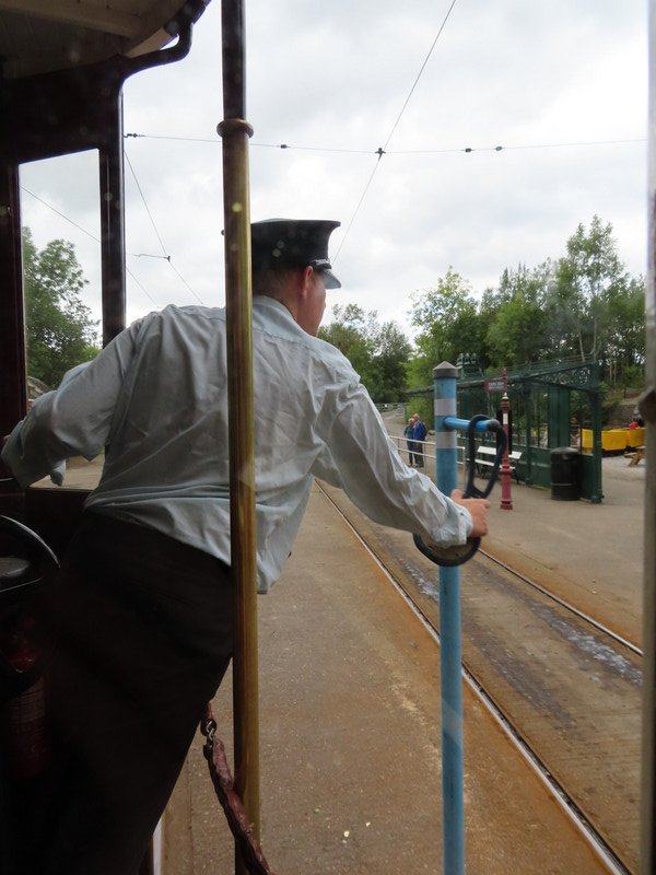 Hanging the token back on the pole to say it is safe for the next tram to come along.