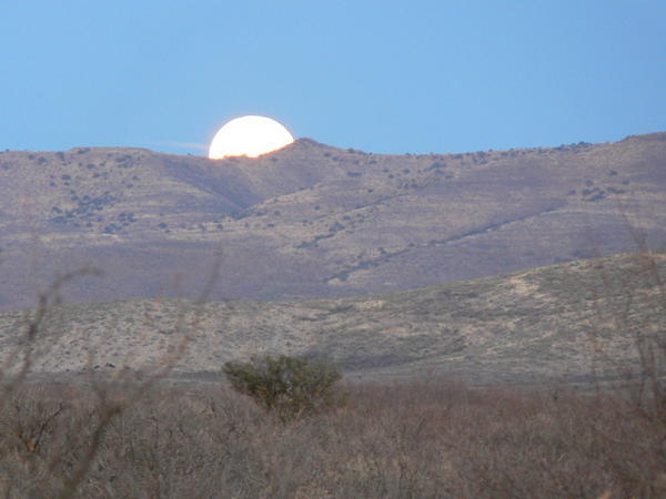 Full moon rising over the mountains