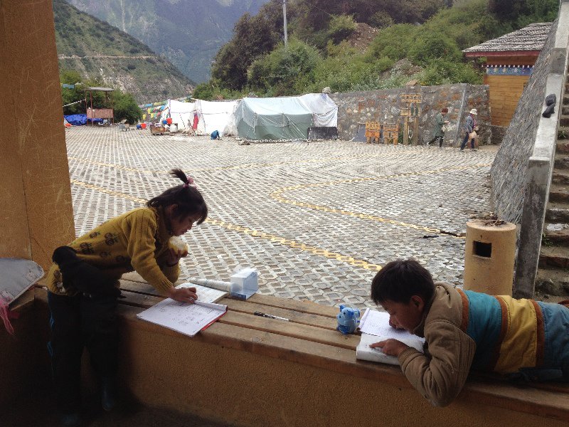 Two Tibetan Kids Doing Homework in A Pavilion