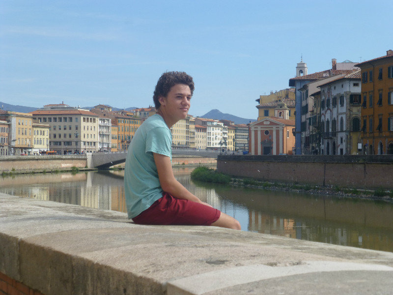 Jake on the edge of the river through Pisa