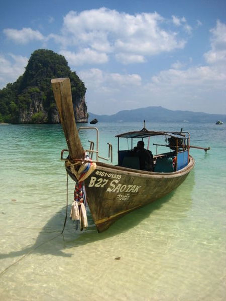typical view: a longtail anchored on a beautiful beach
