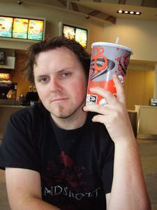 Gaz demonstrating how big a regular soda is at the movies
