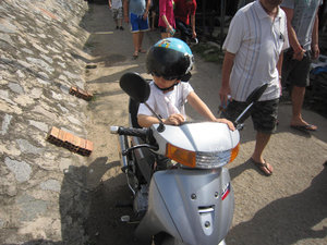 A child waiting on a motorcycle. This made me laugh