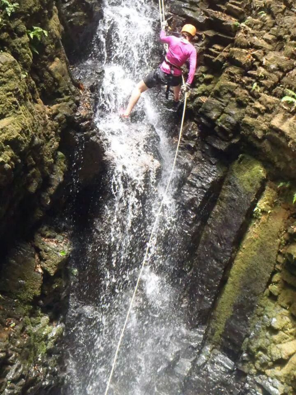 Repelling down a waterfall.