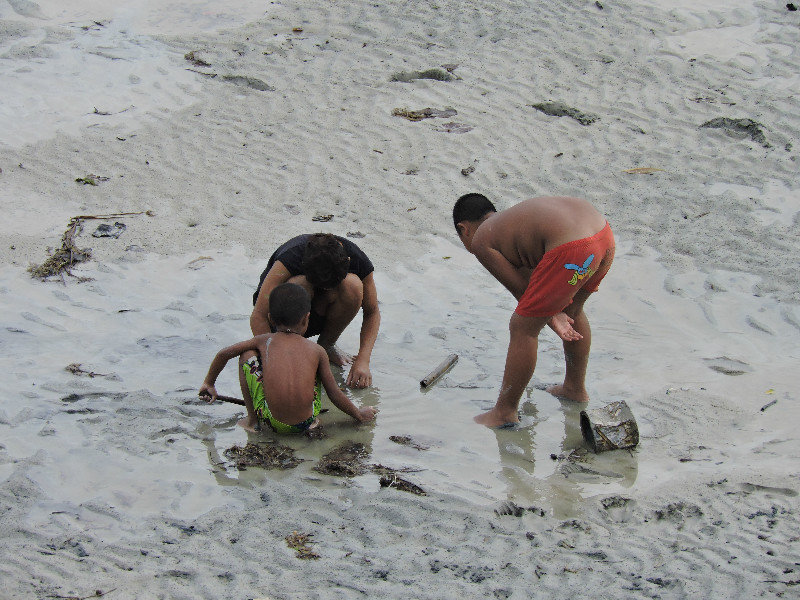 The local children playing with crabs! There were hundreds when the tide was out!