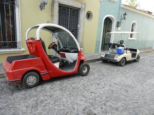 The new red golf cart and the old white one