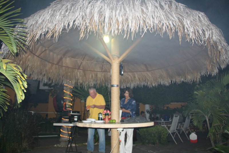 Paul makes everyone nervous with BBQ flames under the palapa.