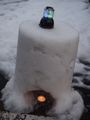 candles in upturned buckets of snow 