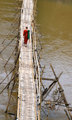 Monk crossing the bamboo bridge