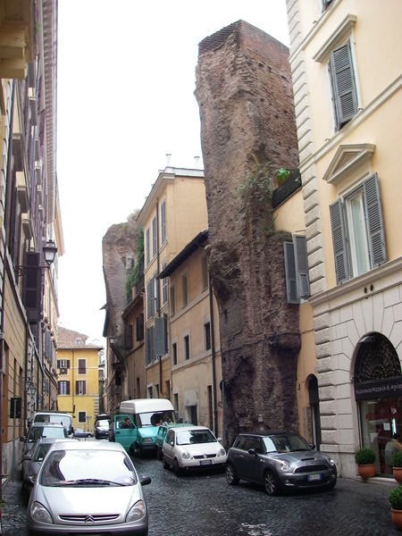 Roman Walls growing out of houses