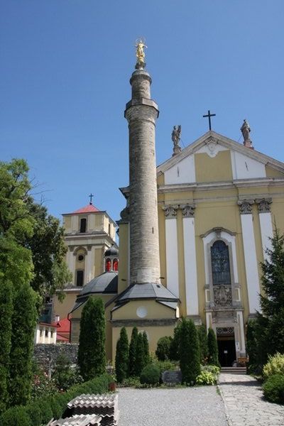 A minaret with a statue of Virgin Mary on top of it