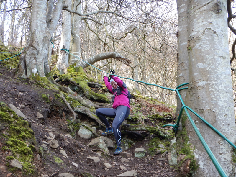 Emma using a rope to get down a steep hill