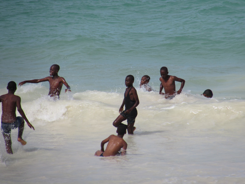 Local children playing in the waves