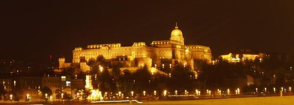 The castle compound at night from across the Danube