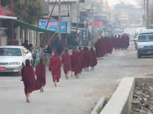 novice monks off to the next food pick up place