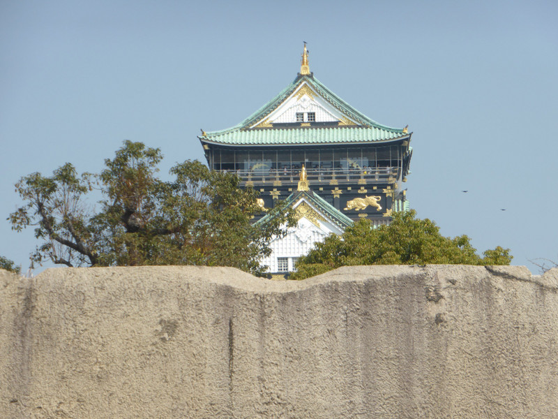 Osaka castle peeking over the moat wall