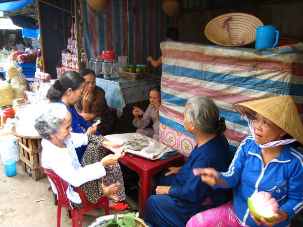 ladies playing cards in the market