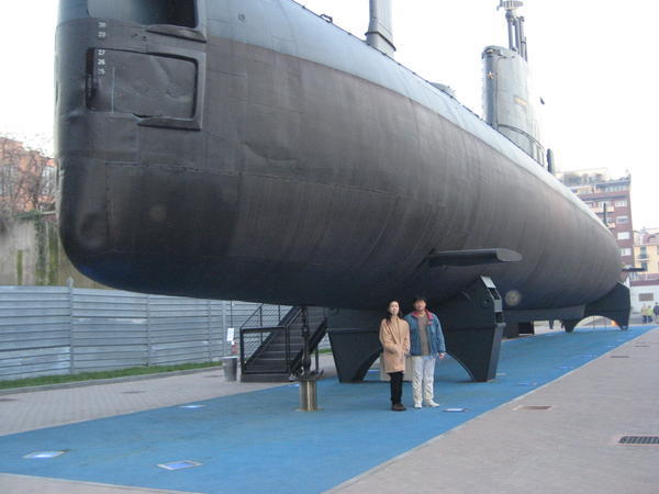Random Asian couple in front of the submarine