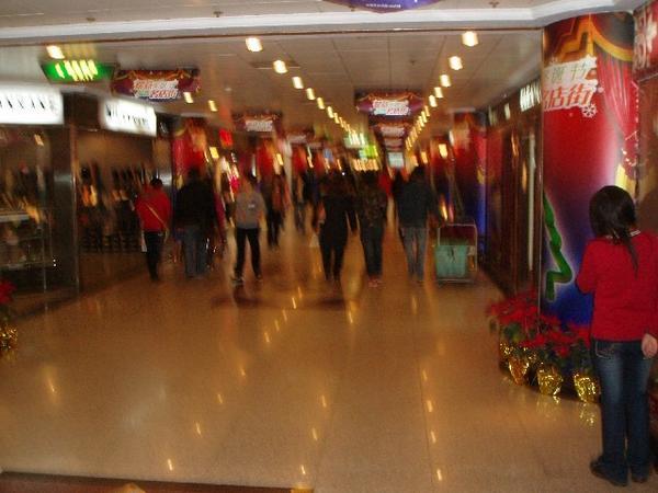 Busy underground shopping mall