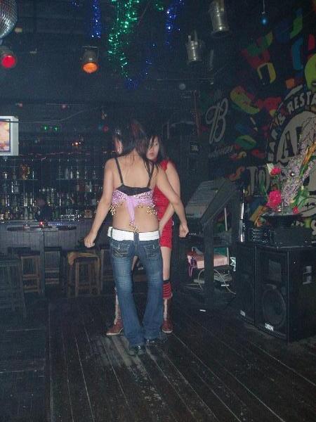 Barmaids dancing with each other!