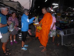 Presenting offering to a monk