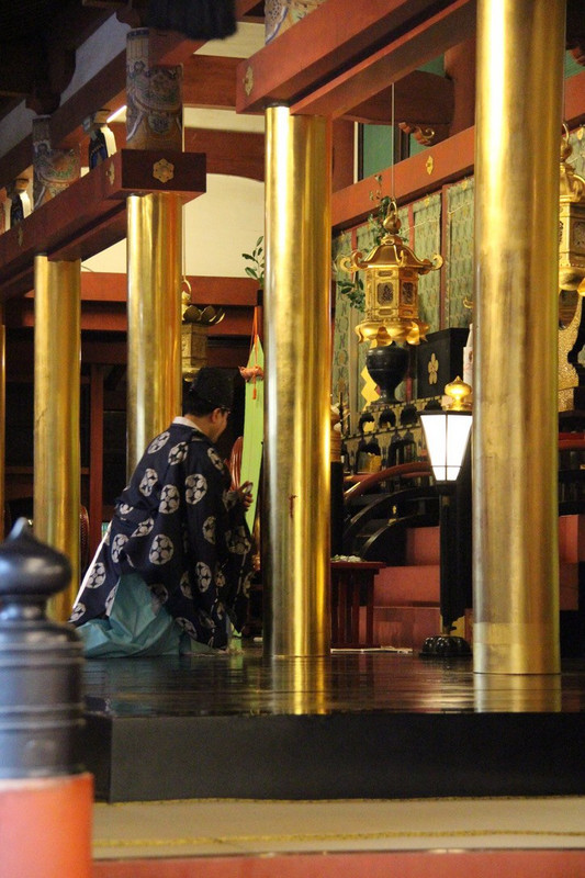 Dazaifu Tenmangu Shrine - priest praying.